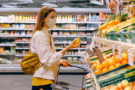 woman wearing face mask in supermarket to do shopping